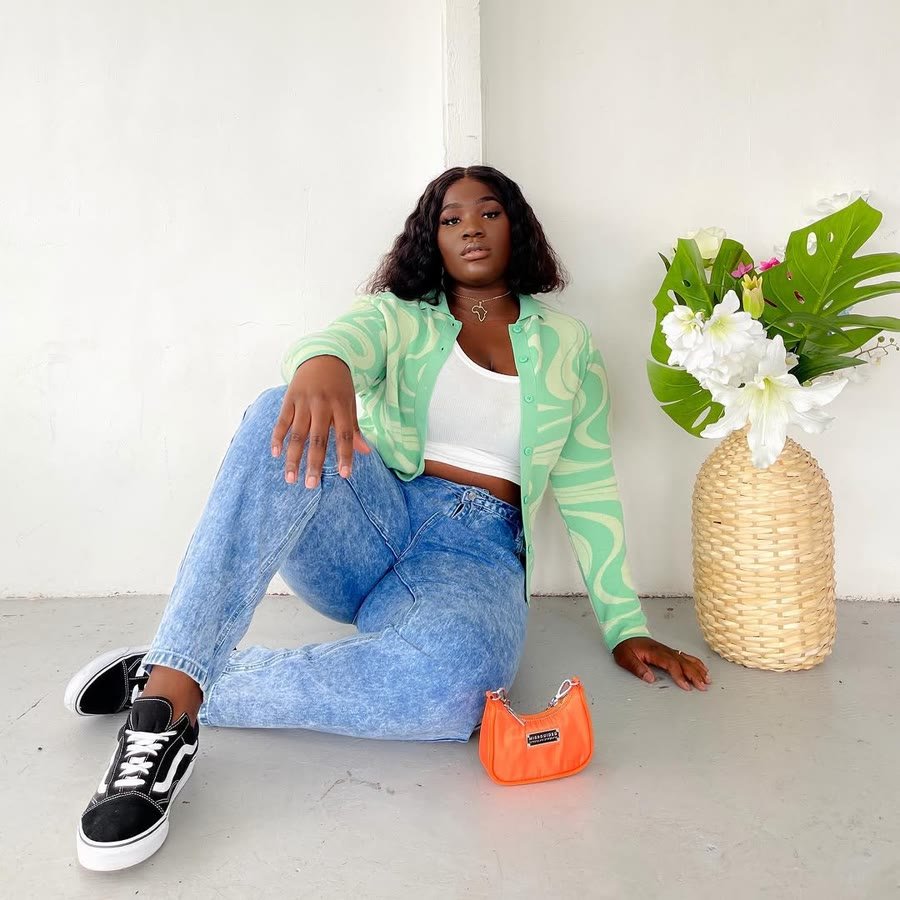 Green knit and denim, shot at home beside a vase of flowers