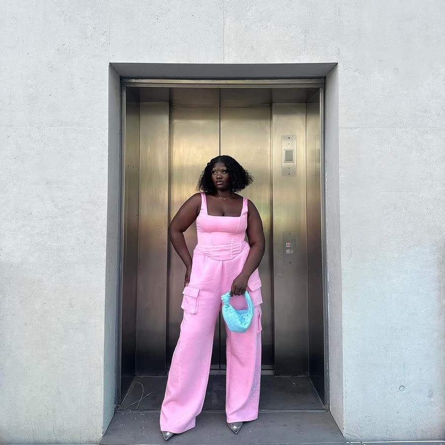 Pink co-ord photographed against a steel lift door